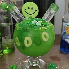 a green drink in a glass with shamrock decorations