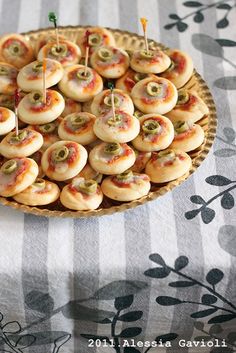 small appetizers are arranged on a platter with toothpicks in them