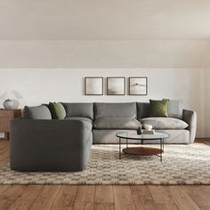 a living room filled with furniture on top of a hard wood floor covered in rugs