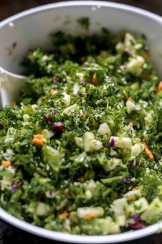 a white bowl filled with chopped vegetables on top of a table