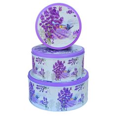 three purple and white boxes stacked on top of each other with flowers painted on them