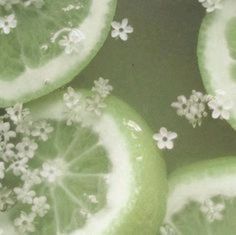 several slices of lime with white flowers on them