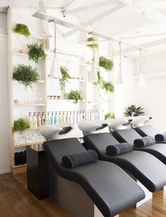 a row of black benches sitting next to each other on top of a hard wood floor