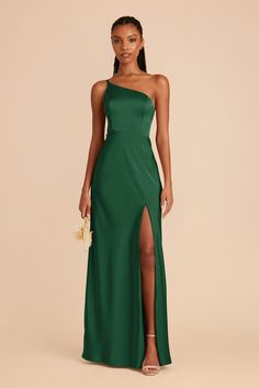 a woman wearing a green dress with one side slit