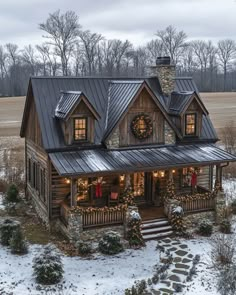 a rustic cabin with christmas lights and wreaths on the front porch