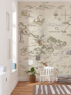 a white rocking chair sitting in front of a wall with a map painted on it