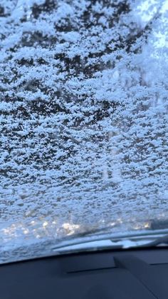 the windshield of a car covered in snow