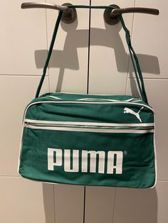 Thank you for visiting Beats and Treats . A vintage ( Unused NOS ) Puma Shoulder Bag Manufactured in the 1970's. I have located 4 of these bags , they have been stored flat in  their plastic bags . If you look at the way the " M" has two indents on the top , that was the logo for the mid to late 1970's. They have that classic shape that is wider at the bottom than the top . Meassurements are 15" X 10" x 7" at the bottom narrowing to 5" at the top. The condition is as new inside and out , just a Retro Bags, Sports Bags Gym, Sports Gym, Gym Bags, Sport Gym, Team Sports, Canvas Shoulder Bag, Plastic Bags, Sport Bag