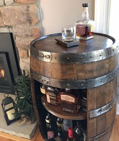 a wooden barrel table with liquor bottles on it