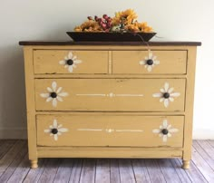 an old dresser with painted flowers on it