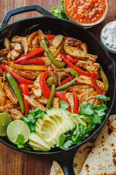 chicken fajita skillet with peppers, avocado and cilantro