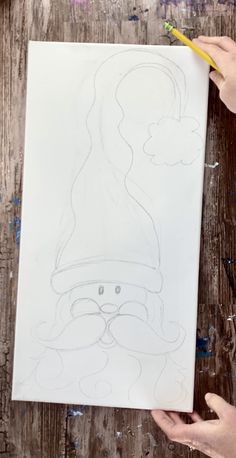 someone is drawing a santa clause on a piece of paper with crayon pencils