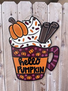 a sign that says hello pumpkin in front of a wooden fence with an ice cream sundae