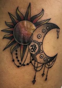 a woman's thigh with a sun and moon tattoo on it