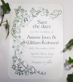 wedding save the date card with ivys and vines on it, surrounded by greenery