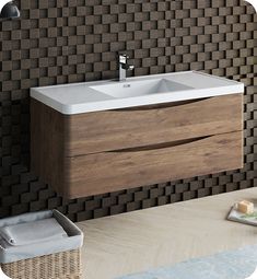 a bathroom sink sitting next to a wall mounted faucet