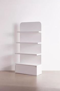 a white book shelf sitting on top of a table