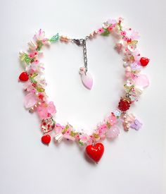 a necklace with hearts, flowers and charms