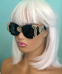 You'll pull off the beautifully bold look of Cleopatra wearing these elegant, stunning black framed sunglasses trimmed in the front & on each side with a gold plated design & a gold & black sparkly brooch in the center.  Perfect for anyone who wants to add an artistic accessory to their wardrobe. UVA & UVB Protection * Hand Polished Frame * Polycarbonate UV400 Lenses * Zipper case & designer wipe included 48mm(W) 41mm(H) 18mm(BR) 145mm Total Frame All of my sunglasses come with a velveteen pouch Rock Star Outfit, Bridal Lehenga Collection, Rhinestone Sunglasses, Lehenga Collection, The Nile, Streetwear Fashion Women, Pull Off