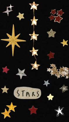 stars are hanging from the side of a black wall