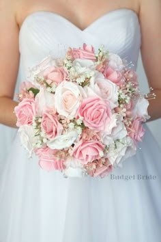 a bridal holding a bouquet of pink and white flowers