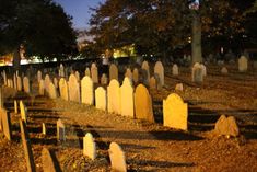 an old cemetery at night with many headstones