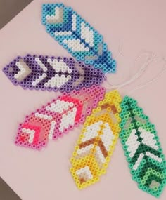 four pieces of beaded art on a table