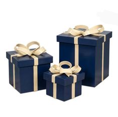 three blue boxes with gold ribbons and bows