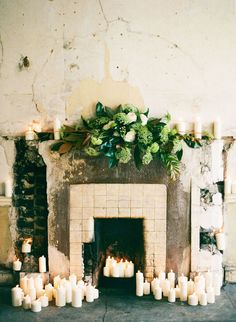 a fire place with candles in front of it