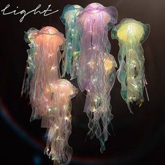 three jellyfish lights hanging from strings in the dark with caption saying light up