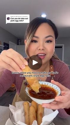 a woman is eating some food on her plate and talking to someone in the background