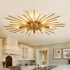 a kitchen with white cabinets and stainless steel counter tops, an island in the center