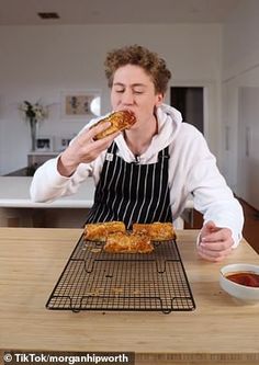 a man in an apron is eating some food