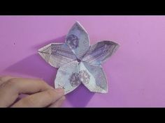 an origami flower on a purple background