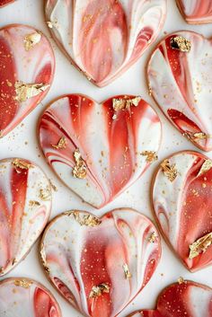 pink and white heart shaped cookies with gold flecks on them, arranged in the shape of hearts