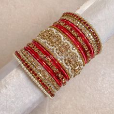 A Large stack of luxurious antique Gold bangles with vibrant red shades and stunning Champagne crystal kada bangles.  Perfect for brides or those wanting to make a statement. Ready to Ship! Antique Gold Bangles, Cristal Champagne, Bridal Survival Kit, Kada Bangles, Bangle Stack, Silk Thread Bangles Design, Thread Bangles Design, Bangle Box, Hand Harness