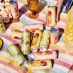 several cans of peach lemonade on a picnic blanket