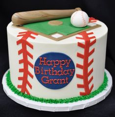 a baseball themed birthday cake with a bat and ball