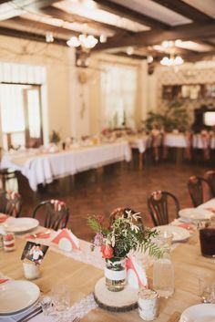 the tables are set with flowers and place settings