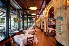 the inside of a restaurant with tables and chairs