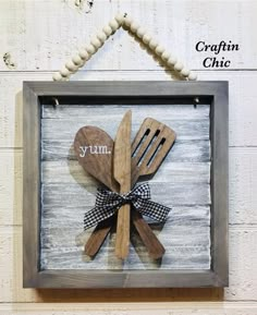 wooden utensils and spoons are mounted in a frame with the word yum written on it