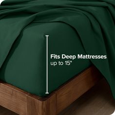 a bed with green sheets and the measurements for it's deep mattress topper