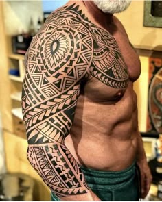 a man with a large tattoo on his arm