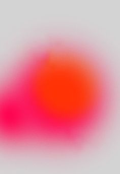 an orange and pink blurry object on a white background