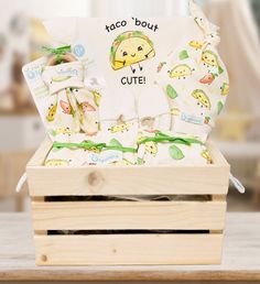 a wooden box filled with baby items on top of a table