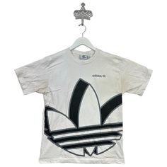 Recommended size: Medium  With discoloration/staining    Great Condition  ★ Era: 2000s MEASUREMENTS: Pit to Pit: 19 in Top to Bottom: 25 in Affordable Adidas Graphic Tee, White Bleached Tops For Streetwear, White Bleached Top For Streetwear, Streetwear Bleached Graphic Tee T-shirt, Adidas Graphic Tee For Streetwear, 90s Style White Streetwear Shirt, White Y2k Shirt For Streetwear, White Y2k Style Shirt For Streetwear, Birthday List