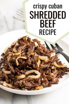 shredded beef is served on a white plate