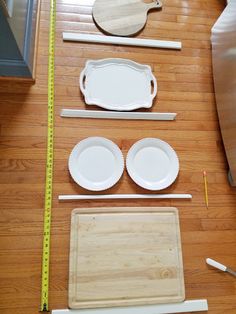 the table is laid out with plates and measuring tape