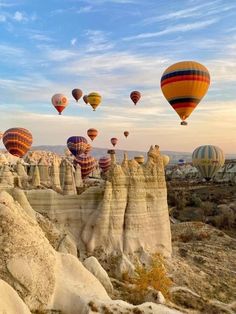 many hot air balloons are flying in the sky