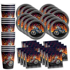 a bunch of plates and cups that have flames on them with the image of a motorcycle